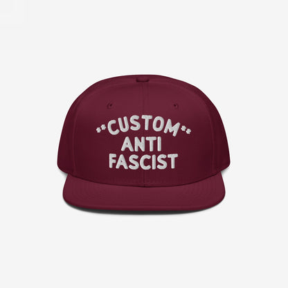 Custom Anti-Fascist Snapback Hat with white embroidered text Custom Anti Fascist on front, designed for personalization. This structured, adjustable cap blends style and a bold anti-fascist message.
