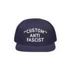 Custom Anti-Fascist Snapback Hat featuring a navy flat-brim design with bold white embroidery. The adjustable snapback offers