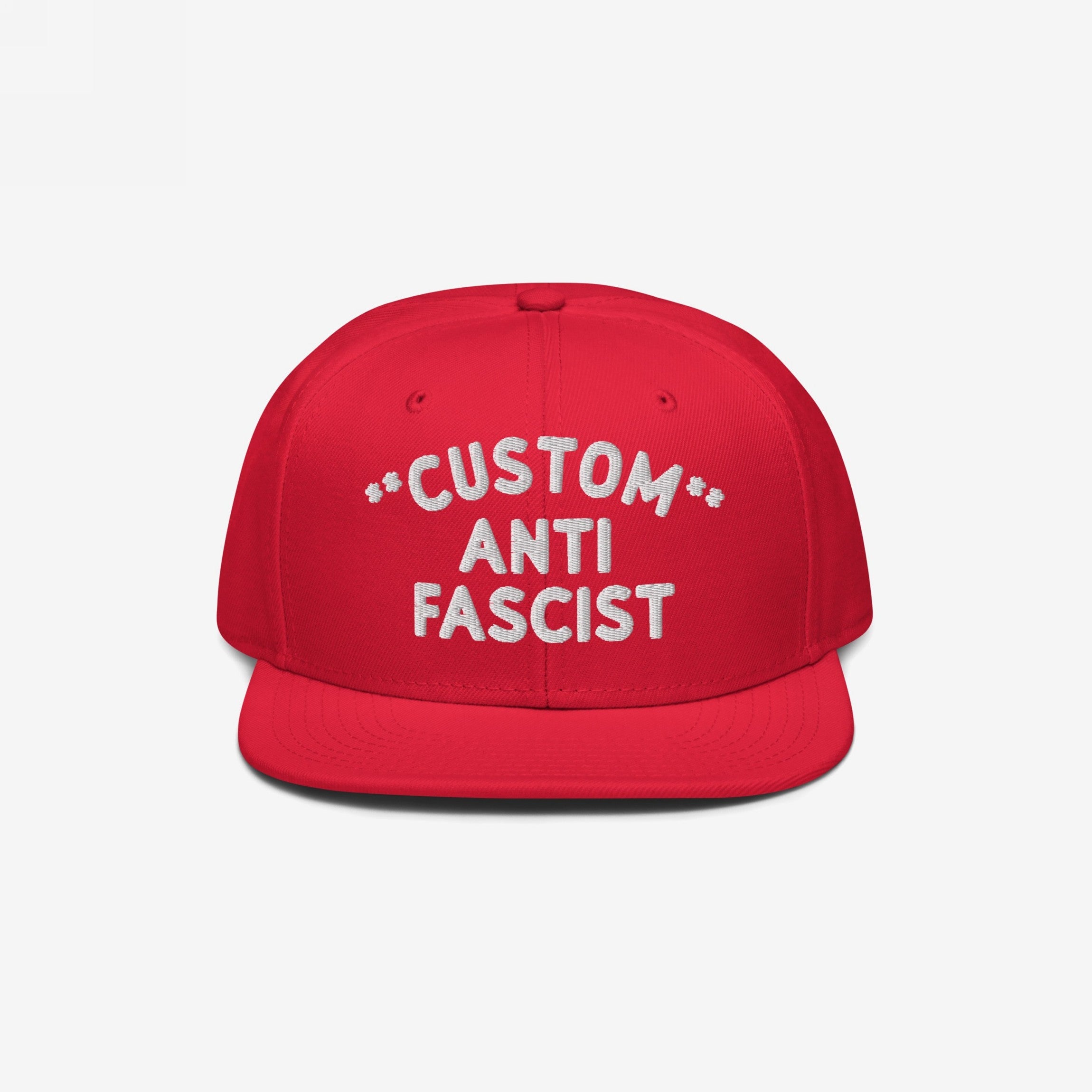 Custom Anti-Fascist Snapback Hat featuring bold white embroidery on a red cap, highlighting the message against fascism. The hat is customizable with your chosen text, offering adjustable fit and personalized style.