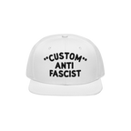 Custom Anti-Fascist Snapback Hat featuring bold black embroidery on a white cap, highlighting an anti-fascist message. Person