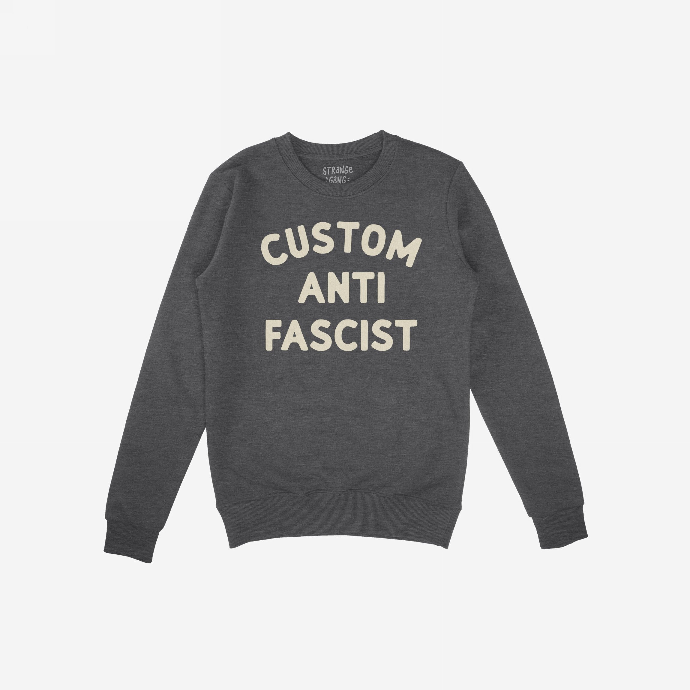 Custom Anti-Fascist Sweatshirt featuring cream block lettering on a charcoal-gray crewneck, ideal for expressing values and personalizing with your choice of text. Perfect for making a statement.