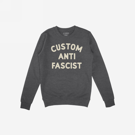 Custom Anti-Fascist Sweatshirt featuring bold off-white lettering on a charcoal crew-neck, perfect for making a statement. Personalize with your message, crafted for comfort and activism.