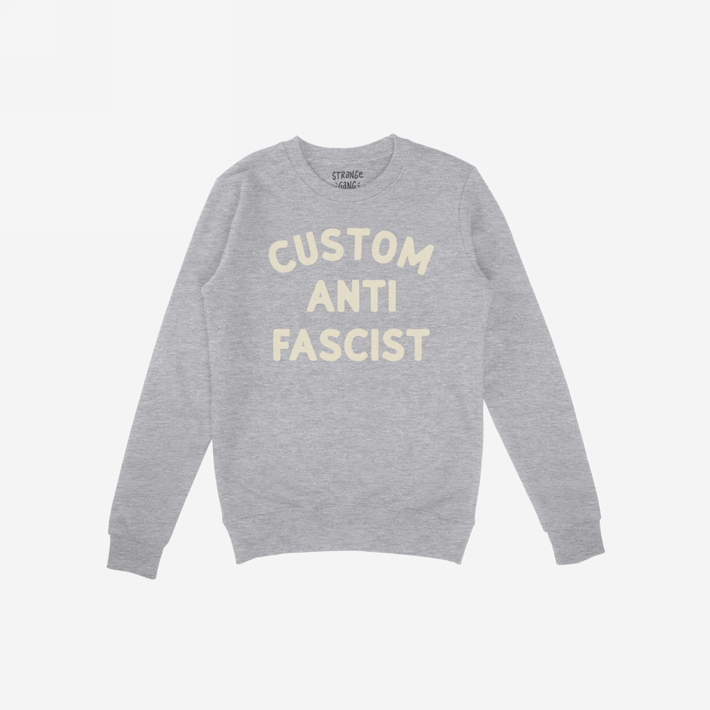 Custom Anti-Fascist Sweatshirt featuring bold cream text, highlighting personal values. Midweight crewneck design ideal for protests or daily wear, inviting personalization on the Custom text for individual expression.