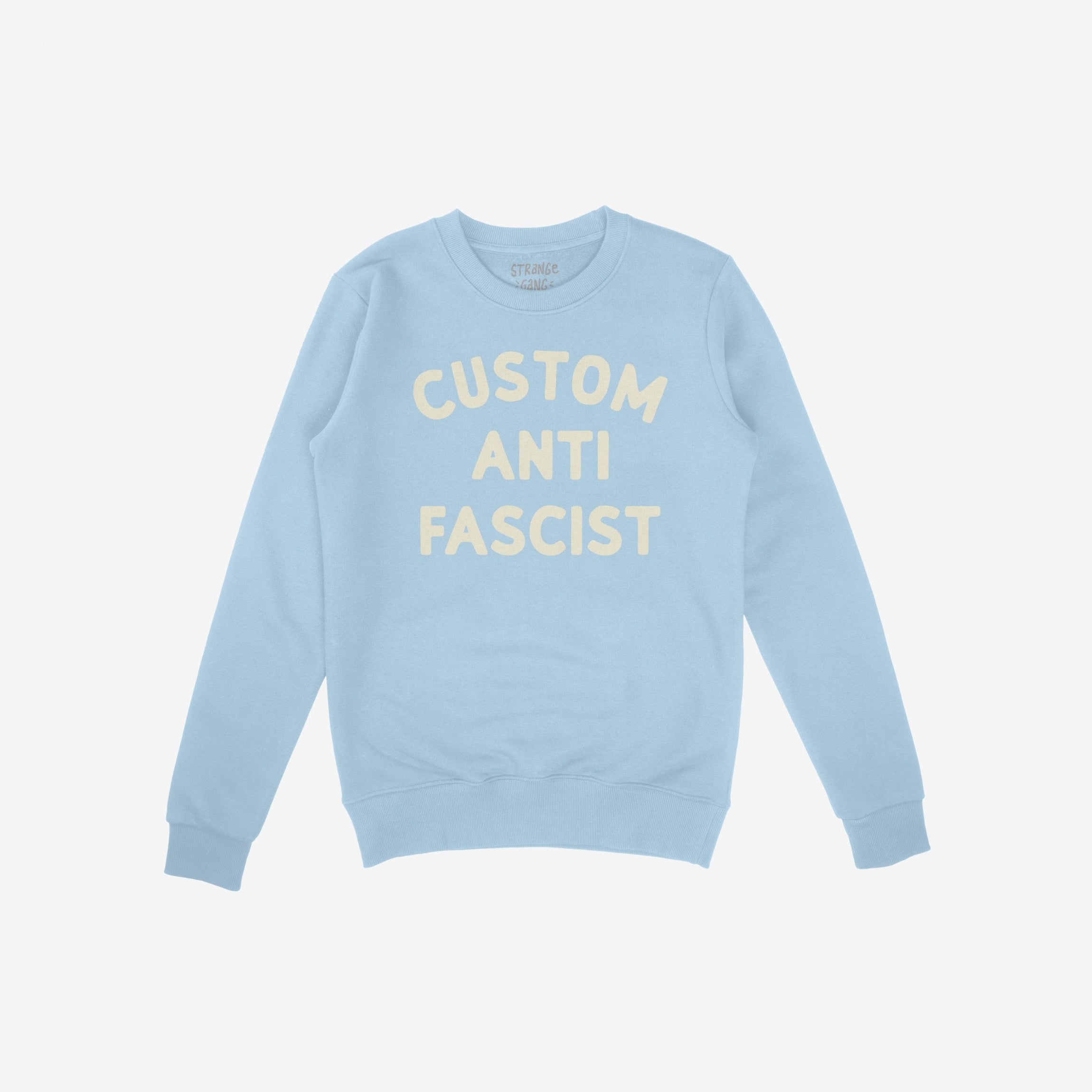 Custom Anti-Fascist Sweatshirt laid flat, featuring CUSTOM ANTI FASCIST in cream block letters on a light-blue crewneck, ribbed cuffs and hem, designed for expressing values and making bold statements.