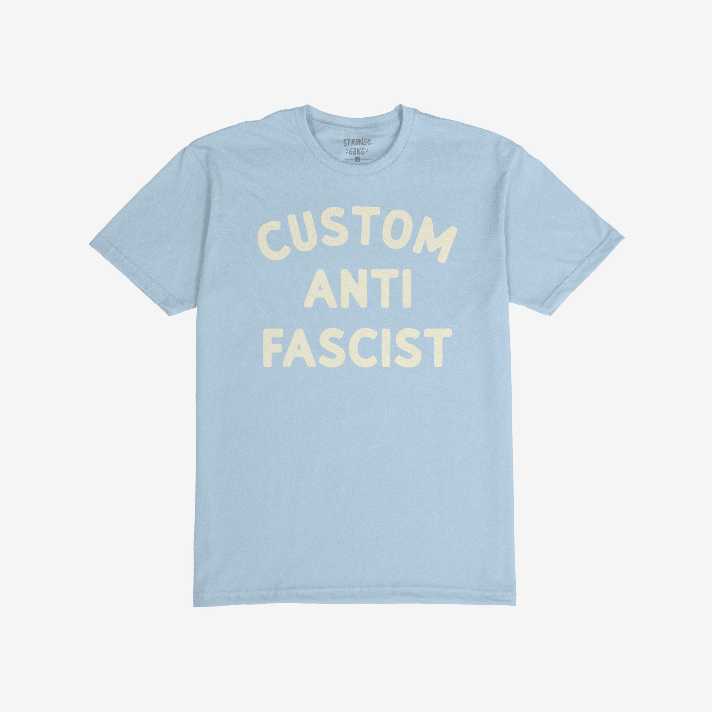 Light blue Custom Anti-Fascist T-shirt with cream block letters reading “CUSTOM ANTI FASCIST” across the front, embodying activism and equality. Ideal for expressing anti-fascist views and supporting community pride.
