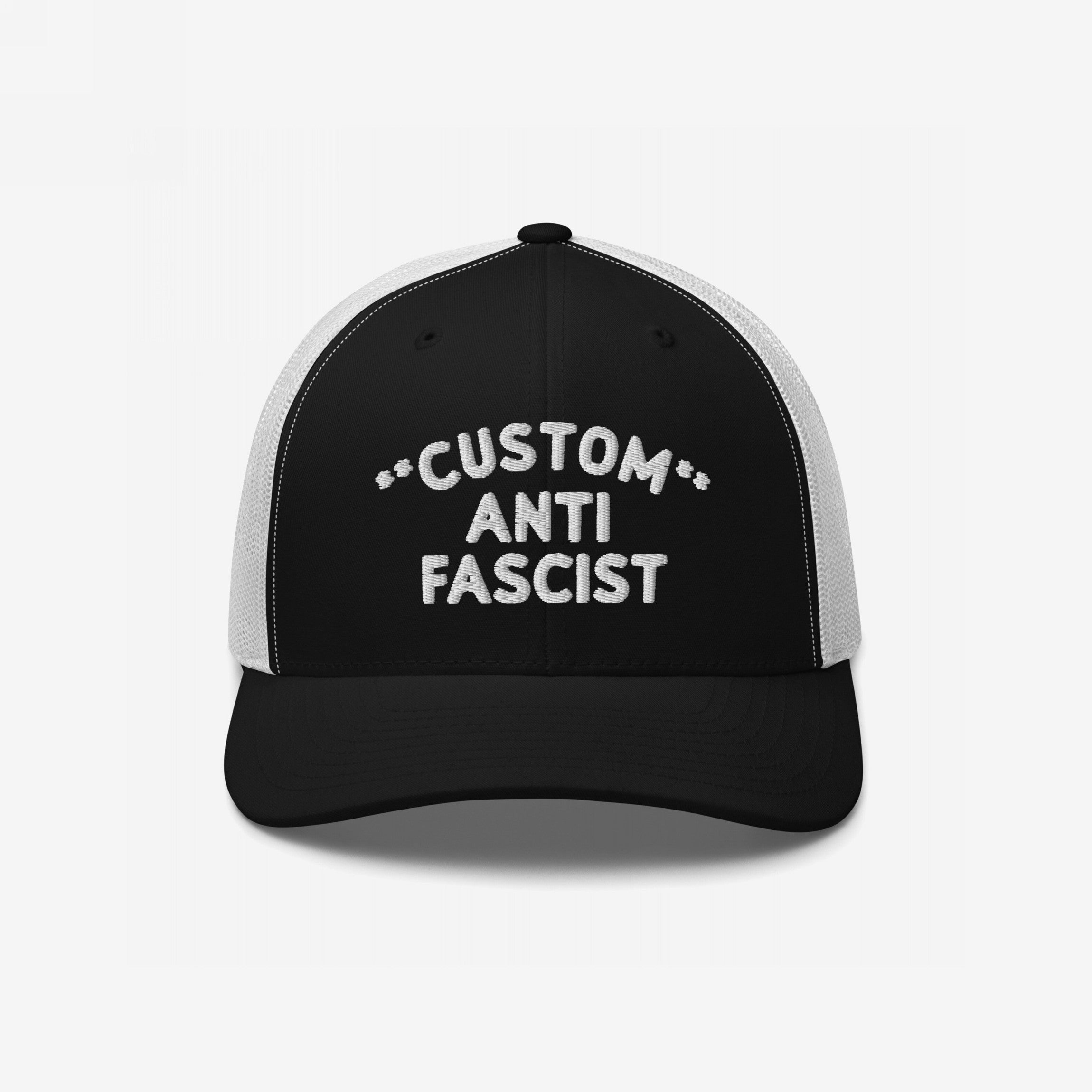 Custom Anti-Fascist Trucker Hat featuring bold white embroidery on a black front panel, breathable white mesh back, and adjustable snap closure, perfect for expressing your stance with style and comfort.