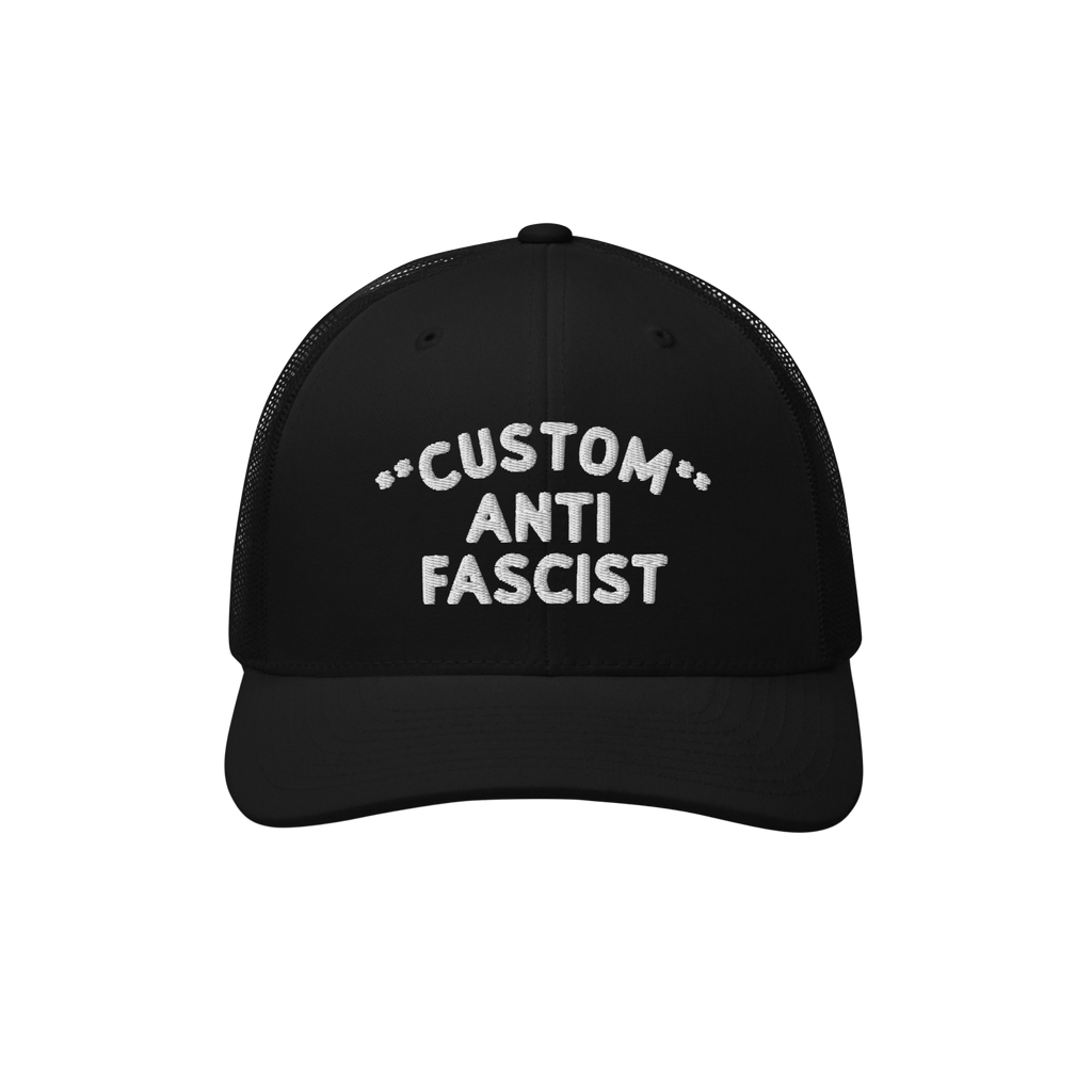 Black mesh-back trucker cap with curved visor, featuring CUSTOM ANTI FASCIST. embroidered in white. Personalize the Custom te