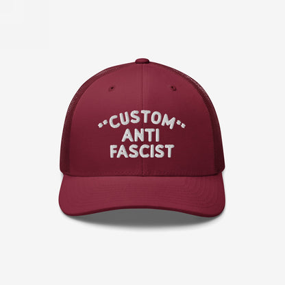Burgundy mesh-back trucker hat with CUSTOM ANTI FASCIST white embroidery on the front. Features breathable mesh, adjustable snap closure, and customizable text, embodying a bold anti-fascist message.