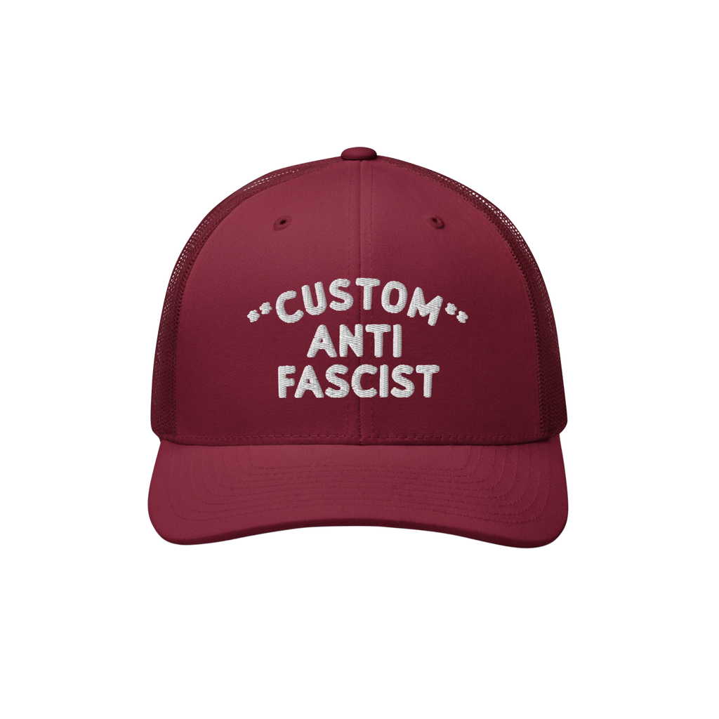 Burgundy mesh-back trucker hat with CUSTOM ANTI FASCIST white embroidery on the front. Features breathable mesh, adjustable s