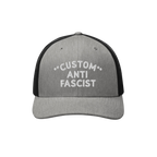 Custom Anti-Fascist Trucker Hat with light gray front, black mesh back, and white embroidered message. Features breathable me