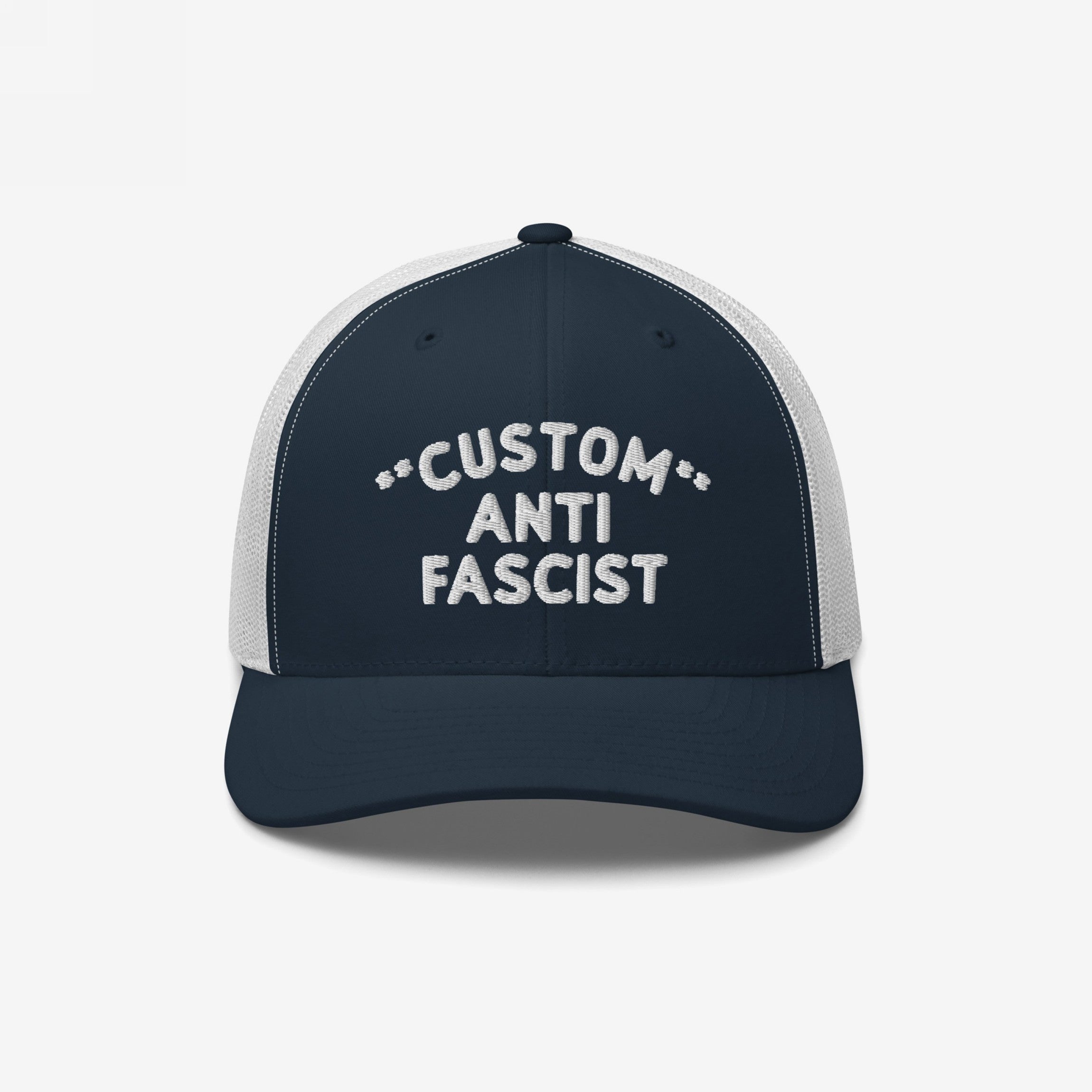 Custom Anti-Fascist Trucker Hat with navy front and white mesh back, featuring CUSTOM ANTI FASCIST embroidered text. Personalizable message, adjustable snap closure, combines style with an anti-fascist statement.