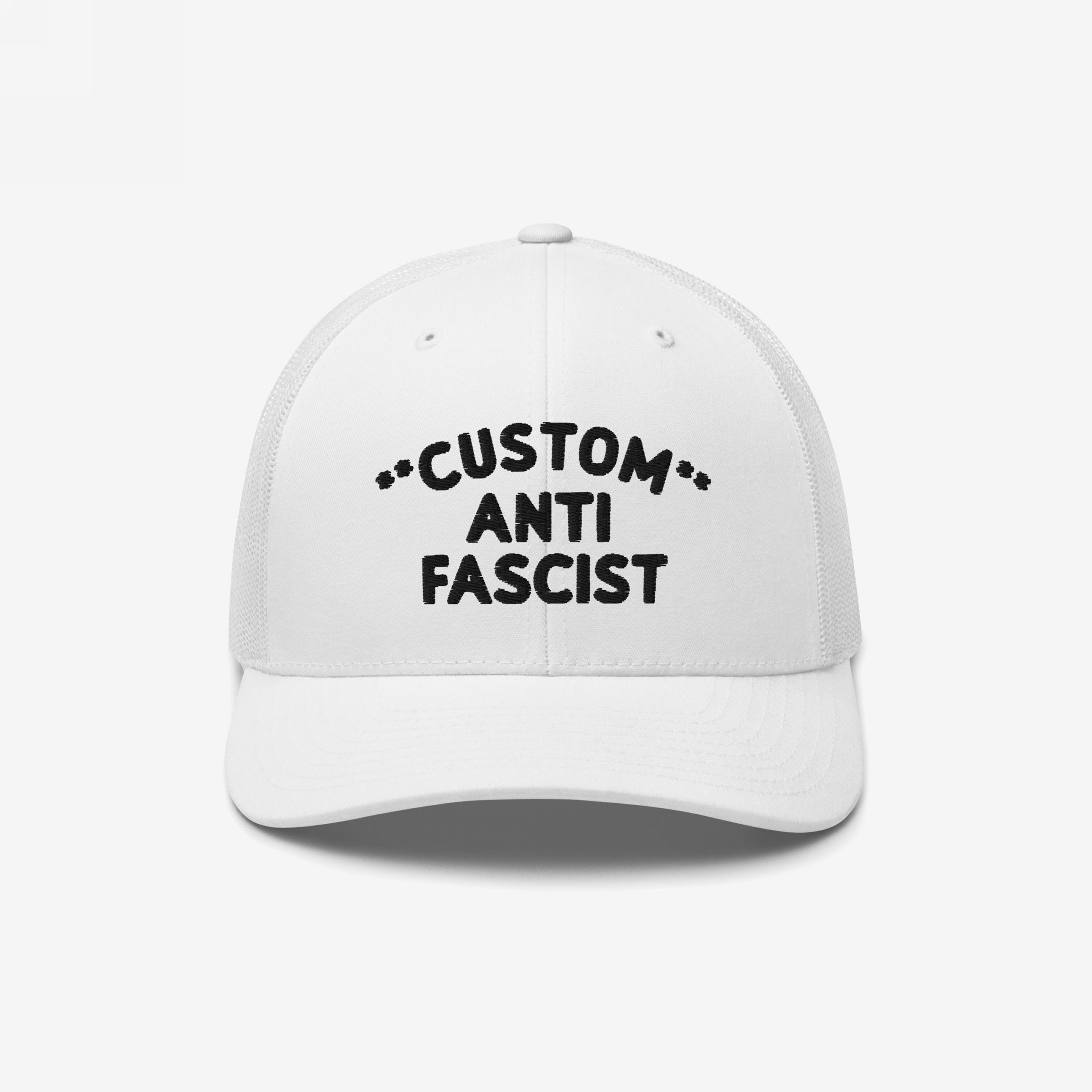 Custom Anti-Fascist Trucker Hat with bold black embroidery on a white front panel, featuring a breathable mesh back and adjustable snap closure, promoting anti-fascism with customizable text options.