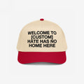 Custom Hate Has No Home Here 5-Panel Hat featuring a beige crown and red brim, with bold black lettering promoting unity and inclusion, customizable with your city name.