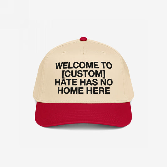 Custom Hate Has No Home Here 5-Panel Hat featuring a beige crown and red brim, with bold black lettering promoting unity and inclusion, customizable with your city name.