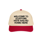Custom Hate Has No Home Here 5-Panel Hat featuring a beige crown and red brim, with bold black lettering promoting unity and 