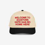 Custom Hate Has No Home Here 5-Panel Hat with beige crown and black brim, featuring bold red embroidered message promoting unity and inclusion, customizable with your city name, designed for justice and equality advocacy.