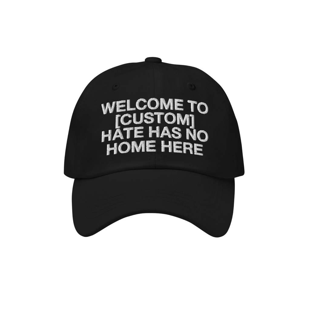 Custom Hate Has No Home Here Dad Hat features a black cap with white embroidered text promoting inclusion. Personalize with y