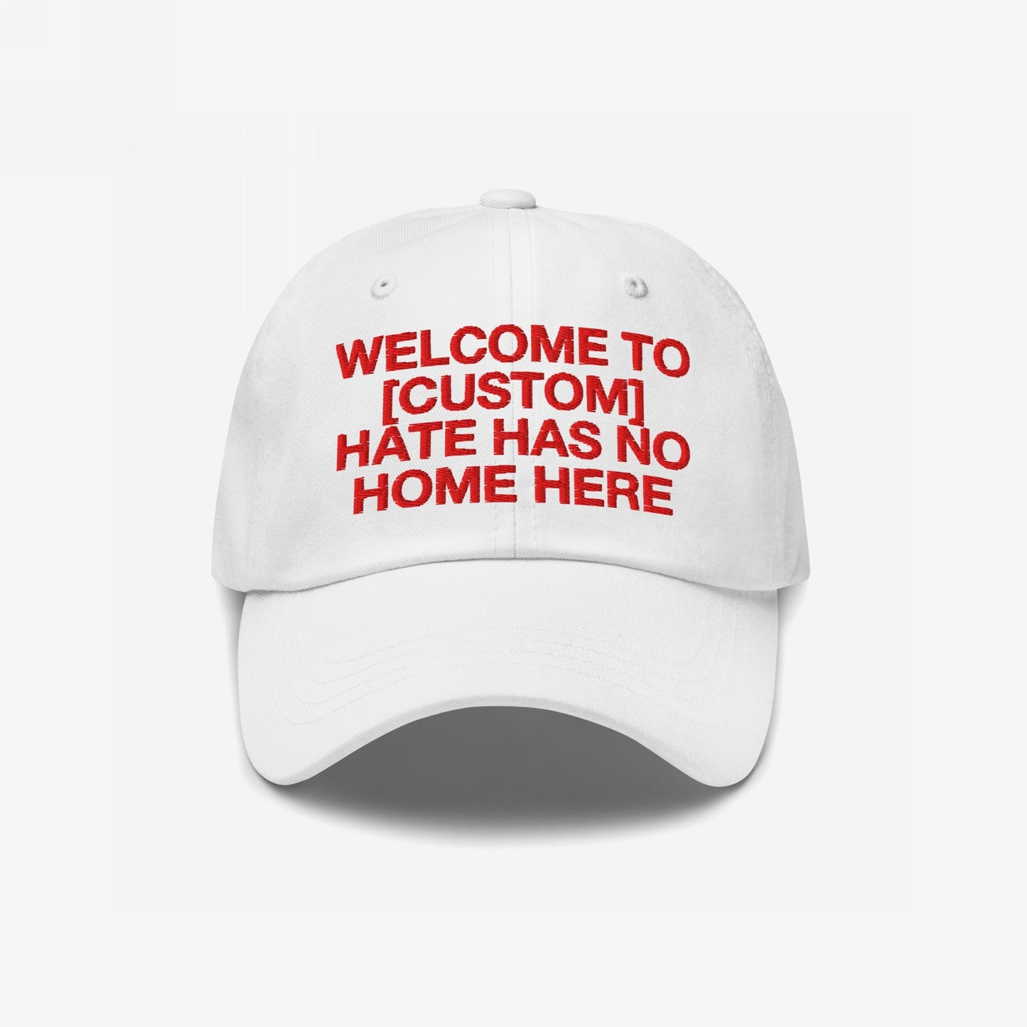 Custom Hate Has No Home Here Dad Hat: White baseball cap with bold red embroidery, customizable text, promoting inclusion and justice. Features adjustable strap and subtle back logo for a personalized, impactful statement.