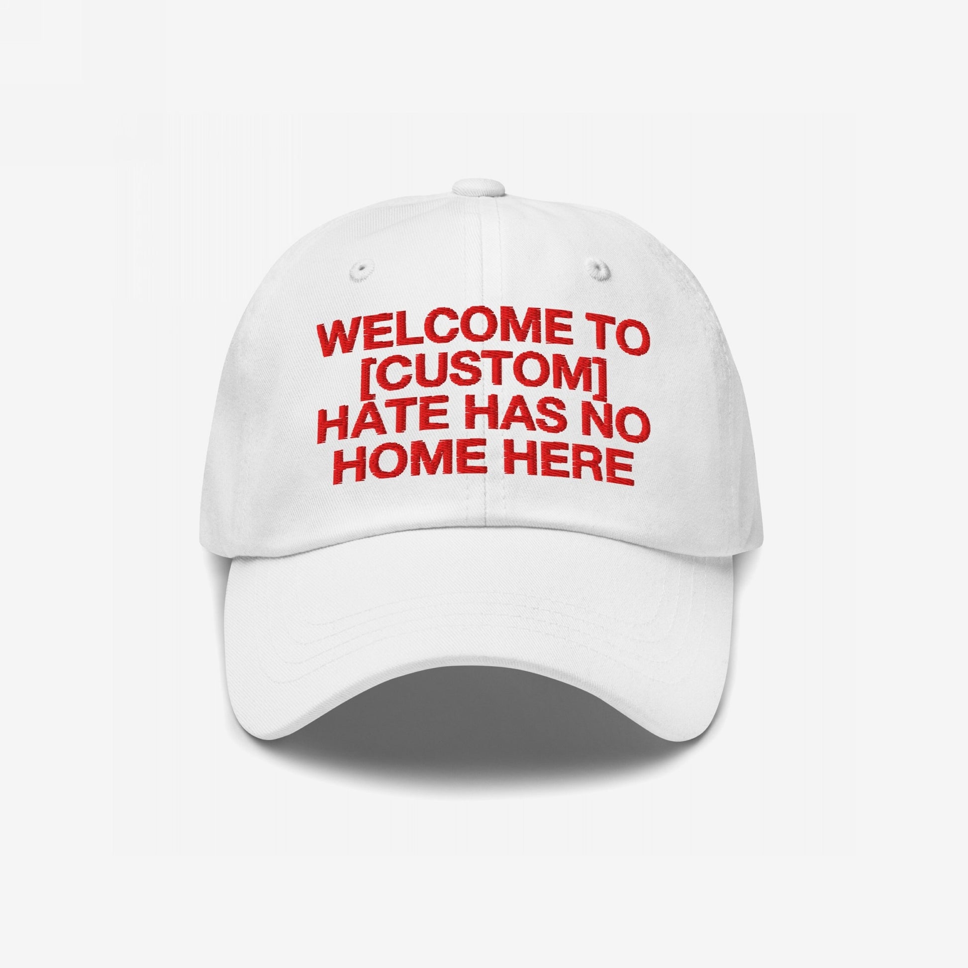 Custom Hate Has No Home Here Dad Hat: White baseball cap with bold red embroidery, customizable text, promoting inclusion and justice. Features adjustable strap and subtle back logo for a personalized, impactful statement.