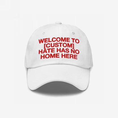 Custom Hate Has No Home Here Dad Hat: White baseball cap with bold red embroidery, customizable text, promoting inclusion and justice. Features adjustable strap and subtle back logo for a personalized, impactful statement.