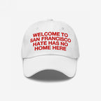 Custom Hate Has No Home Here Dad Hat featuring red embroidered text WELCOME TO SAN FRANCISCO HATE HAS NO HOME HERE, promoting inclusion. Unstructured design with curved brim, adjustable strap, and subtle EGOPROOF logo.