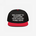 Custom Hate Has No Home Here Snapback Hat features a bold, white embroidered message promoting unity and justice, set against a structured black crown with a contrasting red flat brim and adjustable snap closure.
