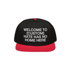 Custom Hate Has No Home Here Snapback Hat features a bold, white embroidered message promoting unity and justice, set against