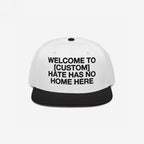 Custom Hate Has No Home Here Snapback Hat with a white crown and black brim, featuring bold black text for personalizing your city name. Embroidered EGOPROOF logo on the back, emphasizing unity and justice.