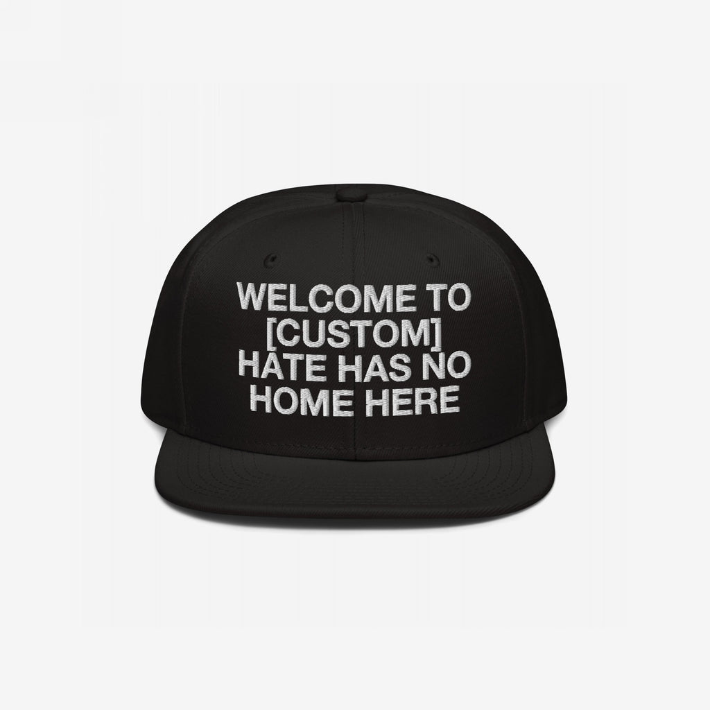 Custom Hate Has No Home Here Snapback Hat featuring bold white embroidery, customizable city name placeholder, structured fit with flat brim, and adjustable snap closure.