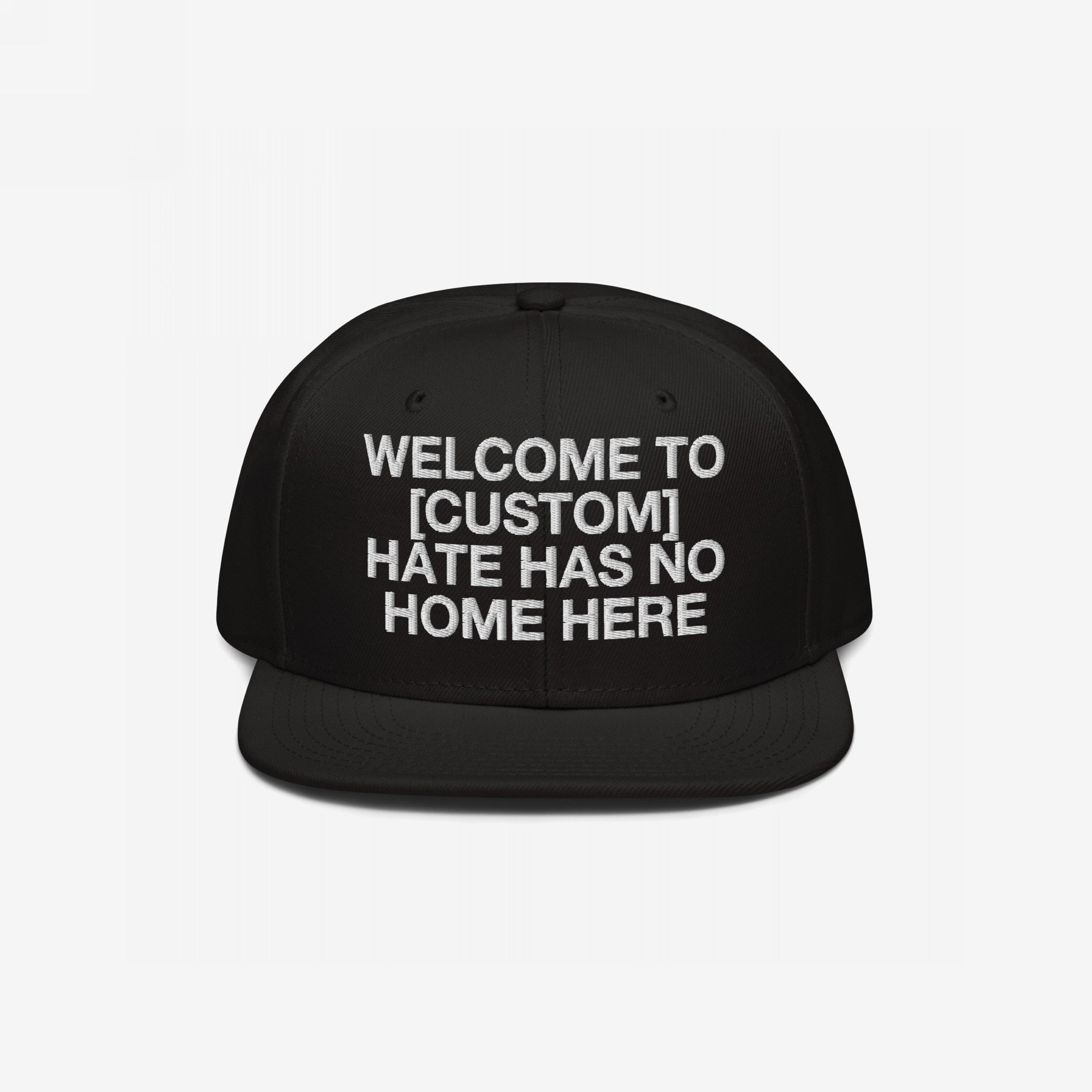 Custom Hate Has No Home Here Snapback Hat featuring bold white embroidery, customizable city name placeholder, structured fit with flat brim, and adjustable snap closure.