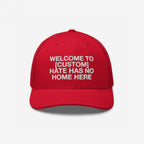 Custom Hate Has No Home Here Trucker Hat with customizable text, featuring white embroidery on a structured front panel and mesh back, representing unity and inclusion. Perfect for community events and everyday wear.