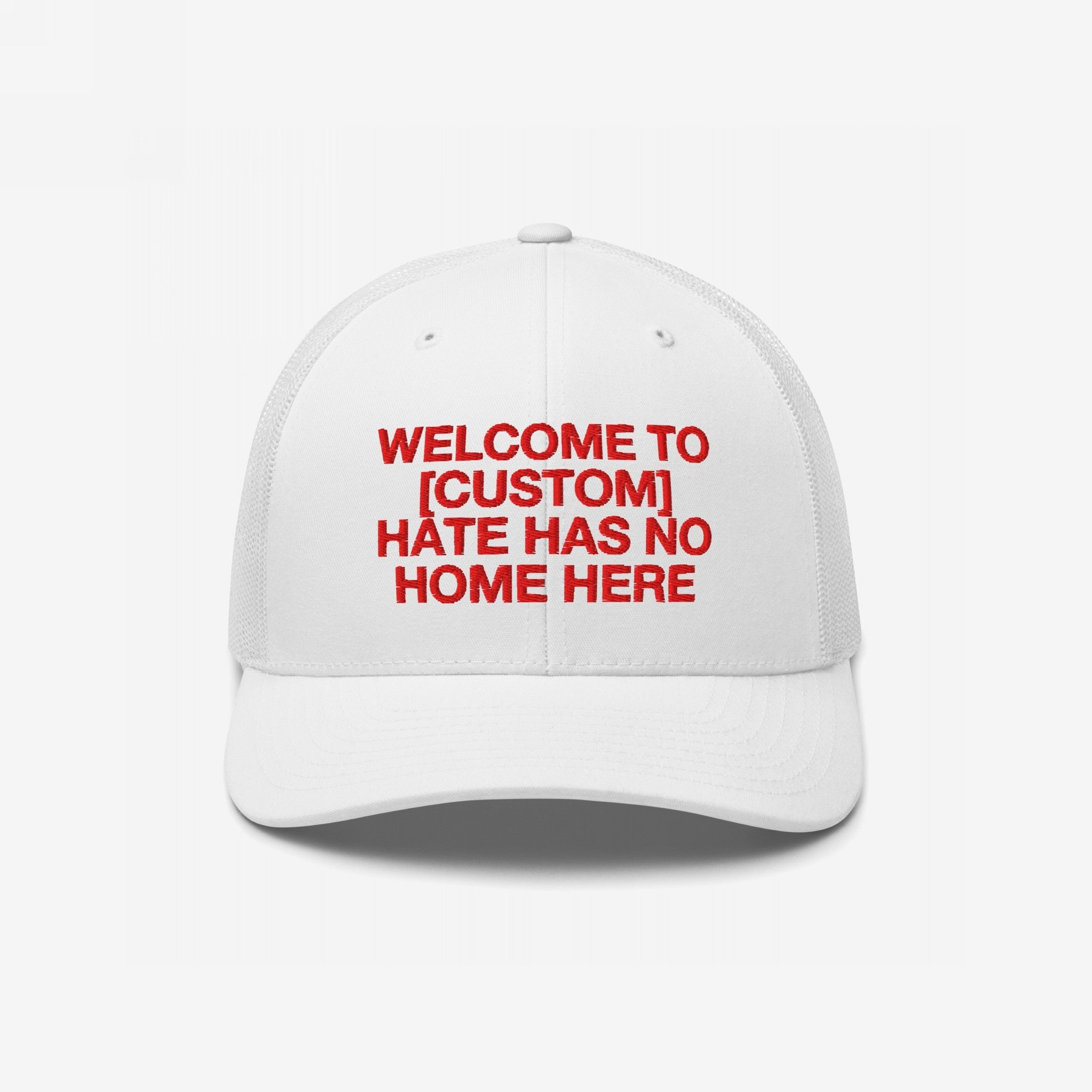 Custom Hate Has No Home Here Trucker Hat: A white cap with red embroidered text, featuring a customizable front for your city, combining comfort and a powerful anti-hate message, ideal for community and everyday wear.