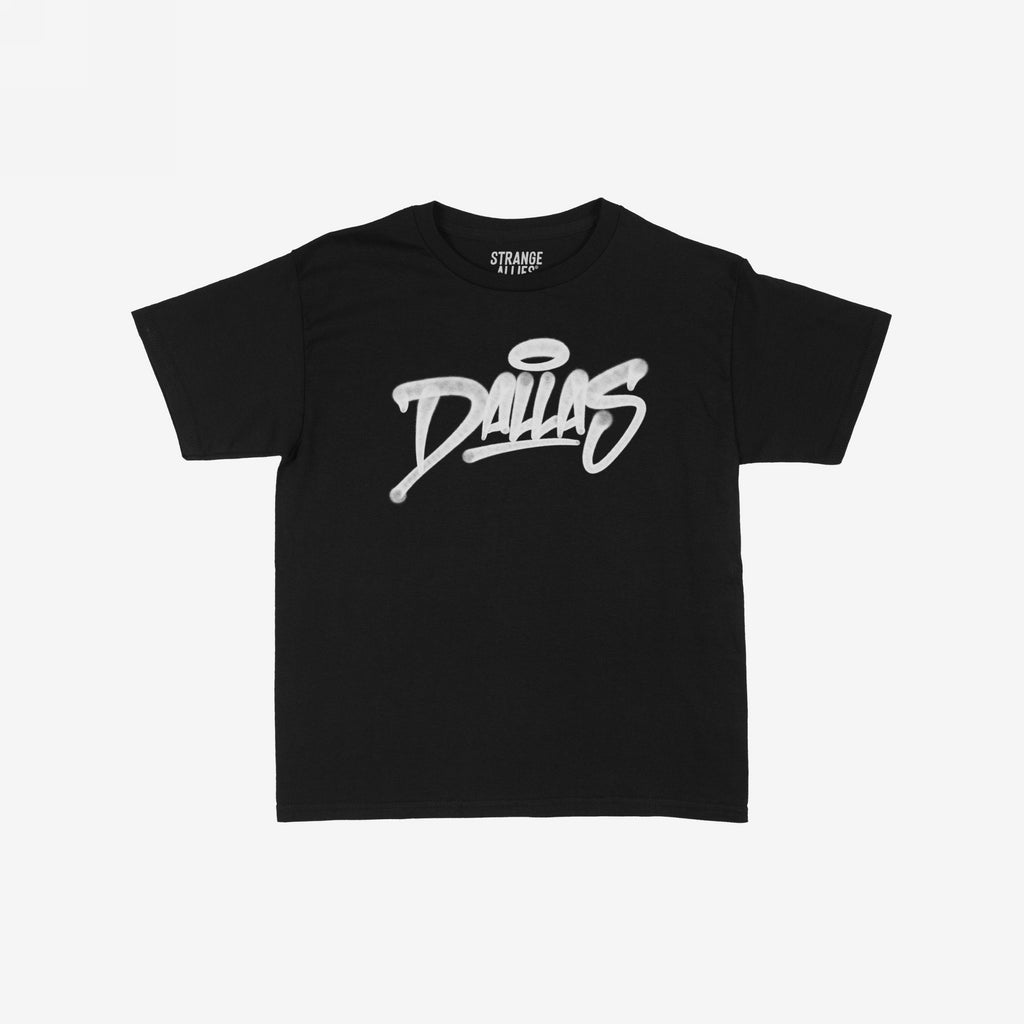 The Dallas Handstyle Women's Baby Tee displays a bold, white graffiti-style Dallas with a halo, on a black T-shirt, embodying a retro Y2K vibe.
