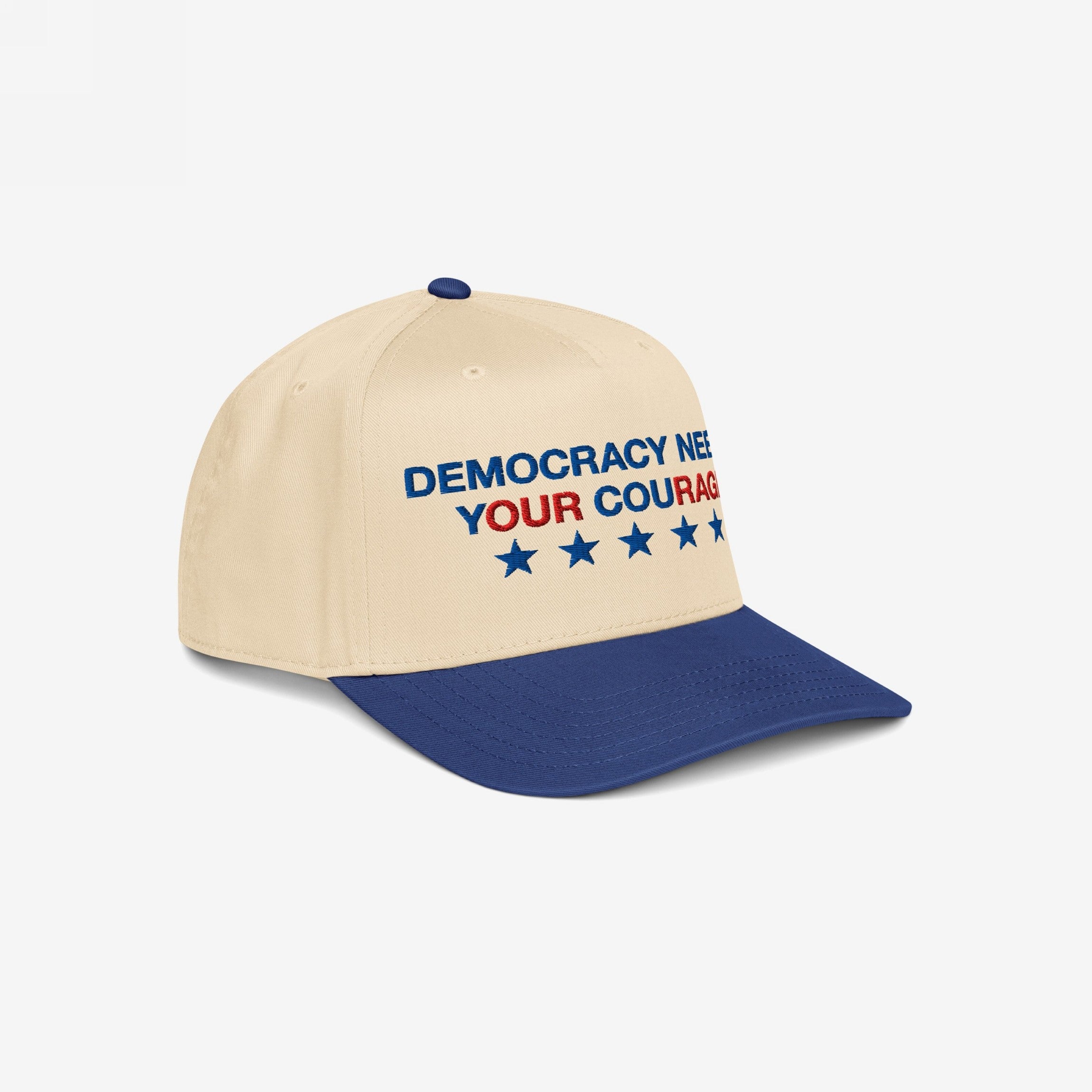 Democracy Hat featuring DEMOCRACY NEEDS YOUR COURAGE embroidery with stars, on a two-tone baseball cap; embodies anti-fascist spirit, available in diverse styles, aligning with inclusive, activist values.