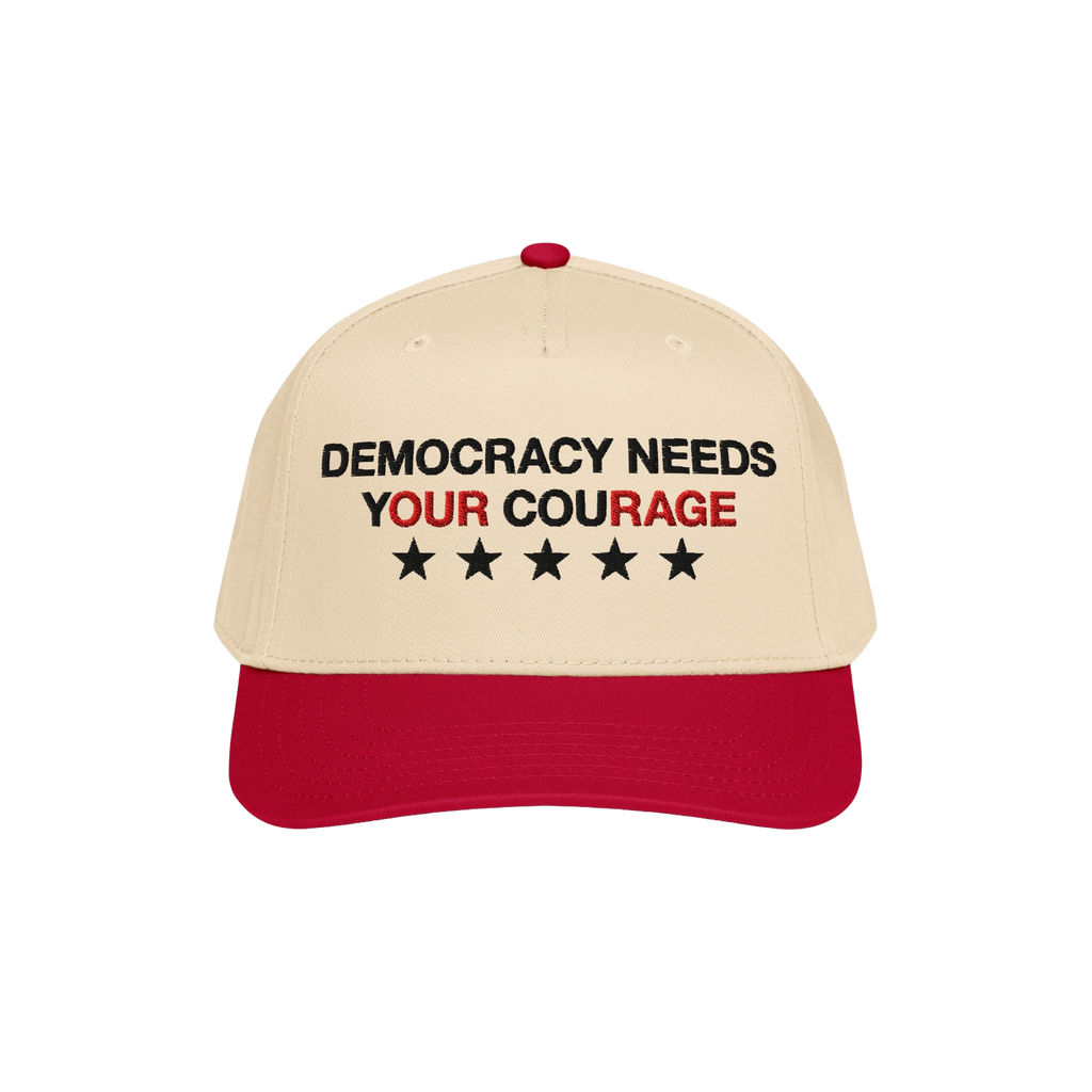 Democracy Hat with a beige crown and red bill, featuring “DEMOCRACY NEEDS YOUR COURAGE” in bold embroidery, ideal for sho