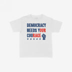 Democracy Women's Baby Tee features a bold, distressed slogan DEMOCRACY NEEDS YOUR COURAGE with a raised fist and five stars, embodying a powerful political message of protest and solidarity.