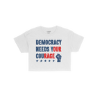 Democracy Women's Baby Tee features a bold, distressed slogan DEMOCRACY NEEDS YOUR COURAGE with a raised fist and five stars,