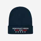 Democracy Hat: A dark-navy ribbed knit beanie featuring “DEMOCRACY NEEDS YOUR COURAGE” embroidered on the cuff, emphasizing Our Rage, with five white stars, embodying anti-fascist and equality values.