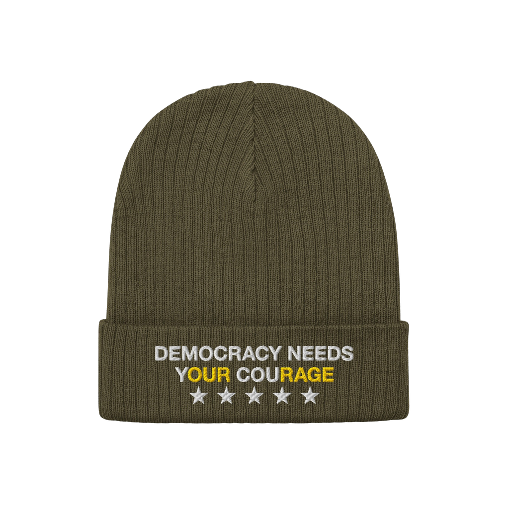 Olive-green knit Democracy Hat with folded cuff, featuring DEMOCRACY NEEDS YOUR COURAGE embroidered in white and yellow, and 
