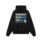 Black pullover hoodie titled Democracy Shirt, featuring the slogan “DEMOCRACY NEEDS YOUR COURAGE” in distressed white and
