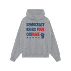 Democracy Shirt: Light-gray hoodie with stencil-style DEMOCRACY NEEDS YOUR COURAGE graphic, featuring distressed stars and ra