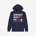 Democracy Shirt: Navy hoodie with DEMOCRACY NEEDS YOUR COURAGE slogan, highlighted in red for impact. Features a front pocket, distressed stars, and raised-fist icon, embodying protest energy and resilience.
