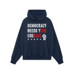 Democracy Shirt: Navy hoodie with DEMOCRACY NEEDS YOUR COURAGE slogan, highlighted in red for impact. Features a front pocket