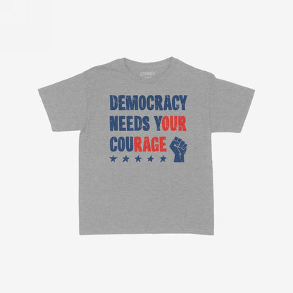 Democracy T-shirt featuring DEMOCRACY NEEDS YOUR COURAGE in red and blue distressed text with stars and a raised fist icon, embodying a bold statement of resistance and unity.