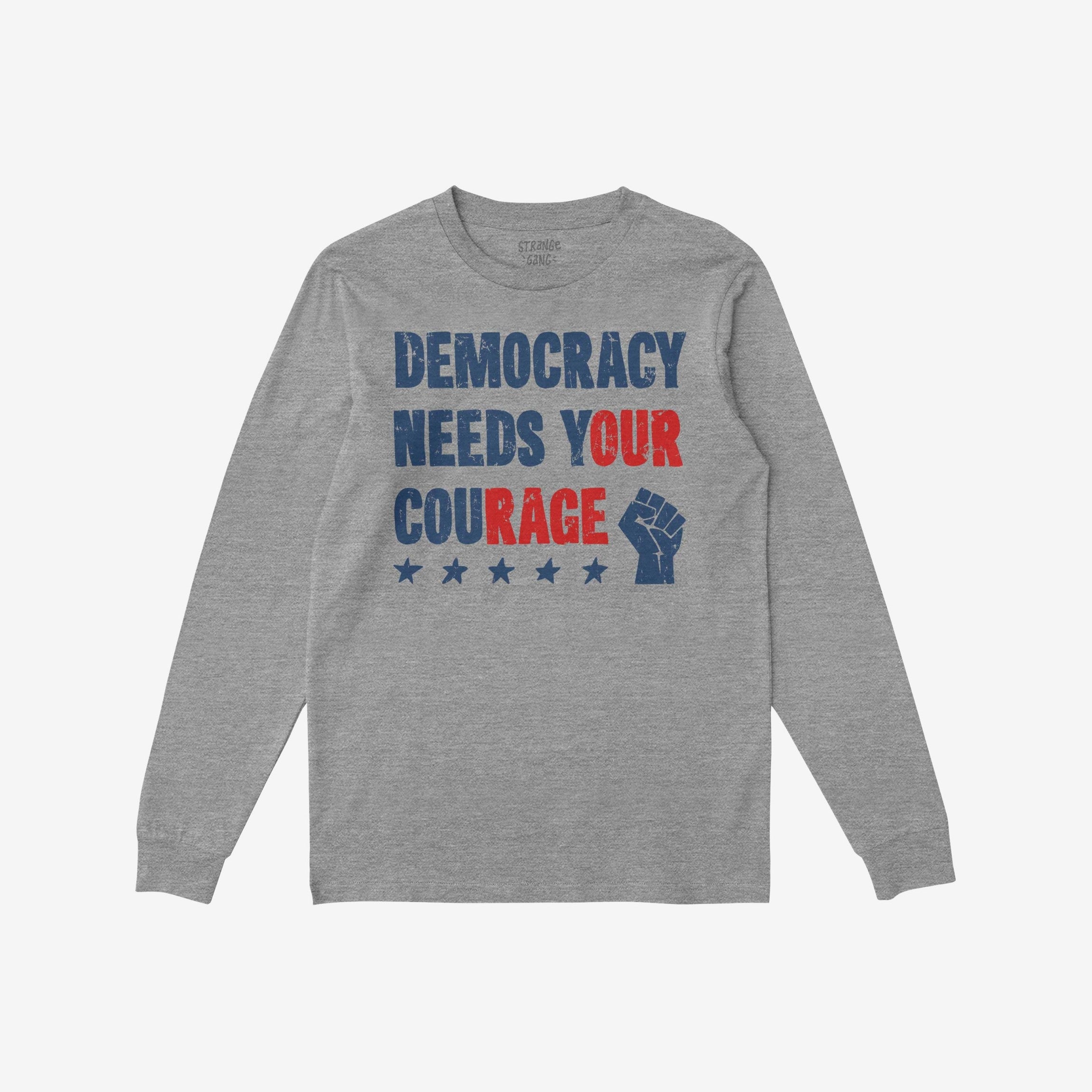 Democracy Shirt displaying the slogan DEMOCRACY NEEDS YOUR COURAGE in distressed red and blue lettering, complete with a raised-fist icon and stars, embodying activism and resistance.