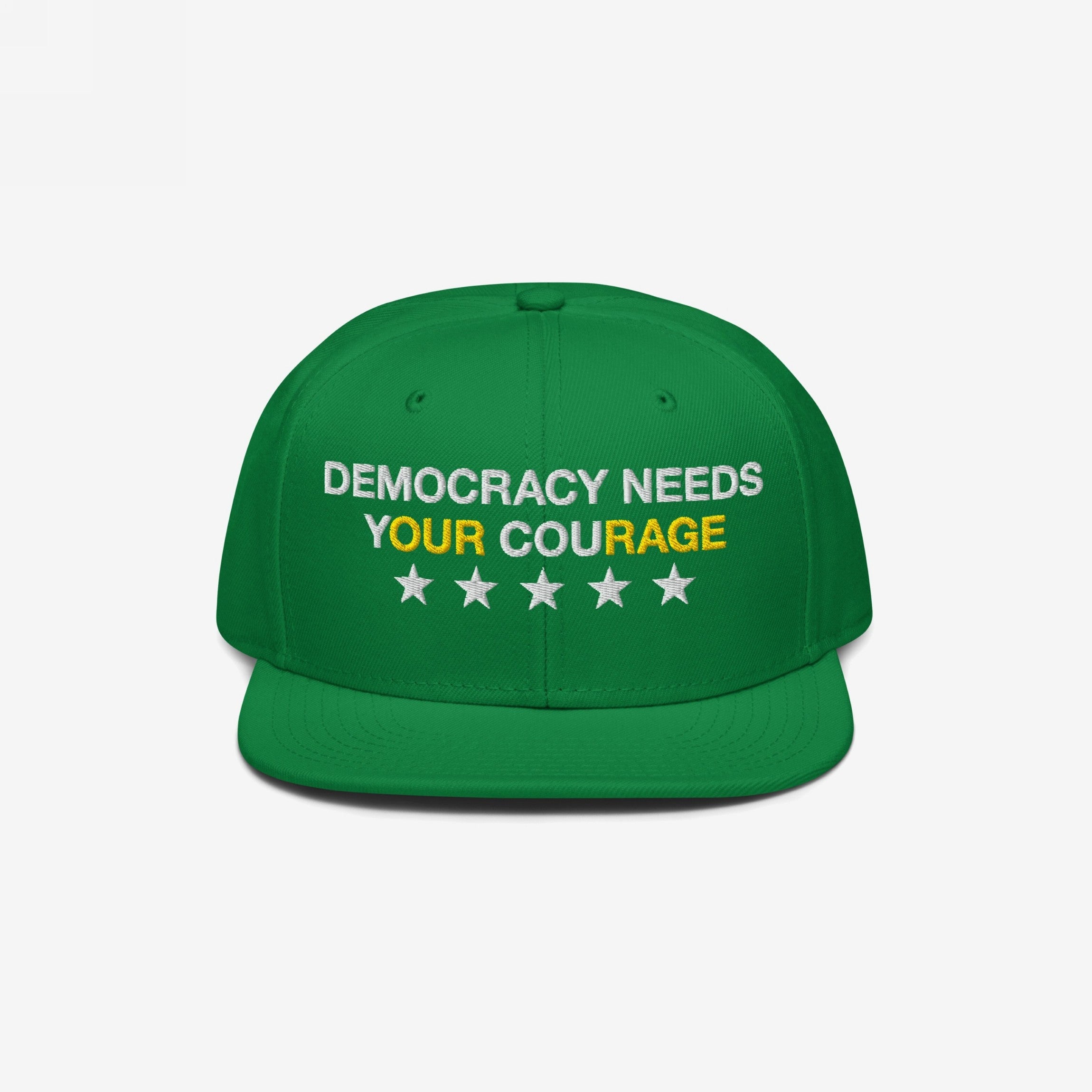 Green Democracy Hat with block letters “DEMOCRACY NEEDS YOUR COURAGE,” highlighting “YOUR COURAGE” in yellow. Features five white stars below, symbolizing resistance against authoritarianism. Ideal for expressing values visibly.