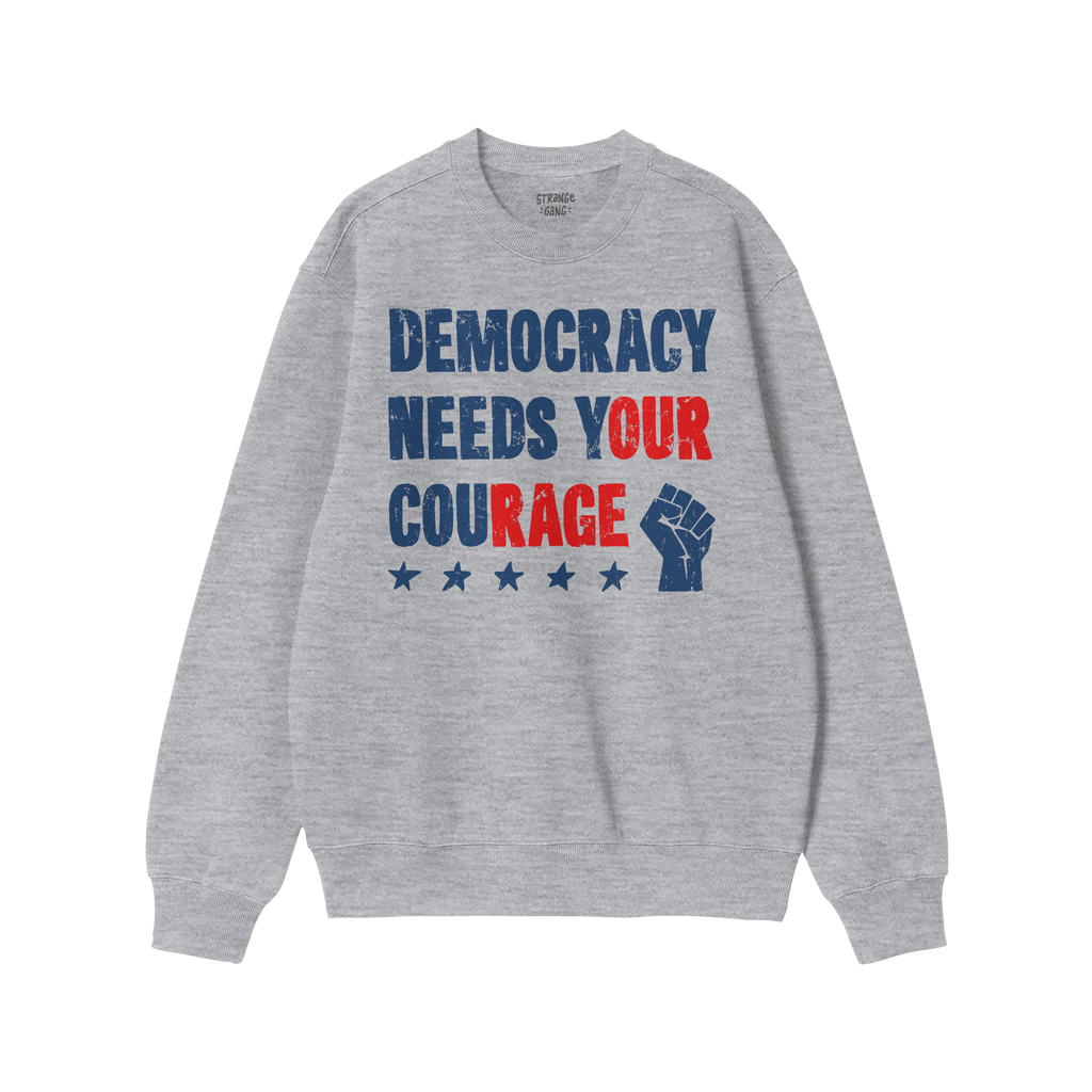 The Democracy Shirt features bold, distressed lettering with the slogan DEMOCRACY NEEDS YOUR COURAGE and a raised-fist icon, 