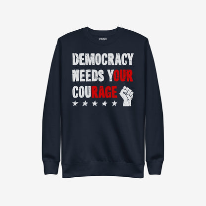 Democracy Hoodie & Sweatshirt featuring a distressed “DEMOCRACY NEEDS YOUR COURAGE” graphic with highlighted text and protest icons, embodying defiance and solidarity in a visually striking design.