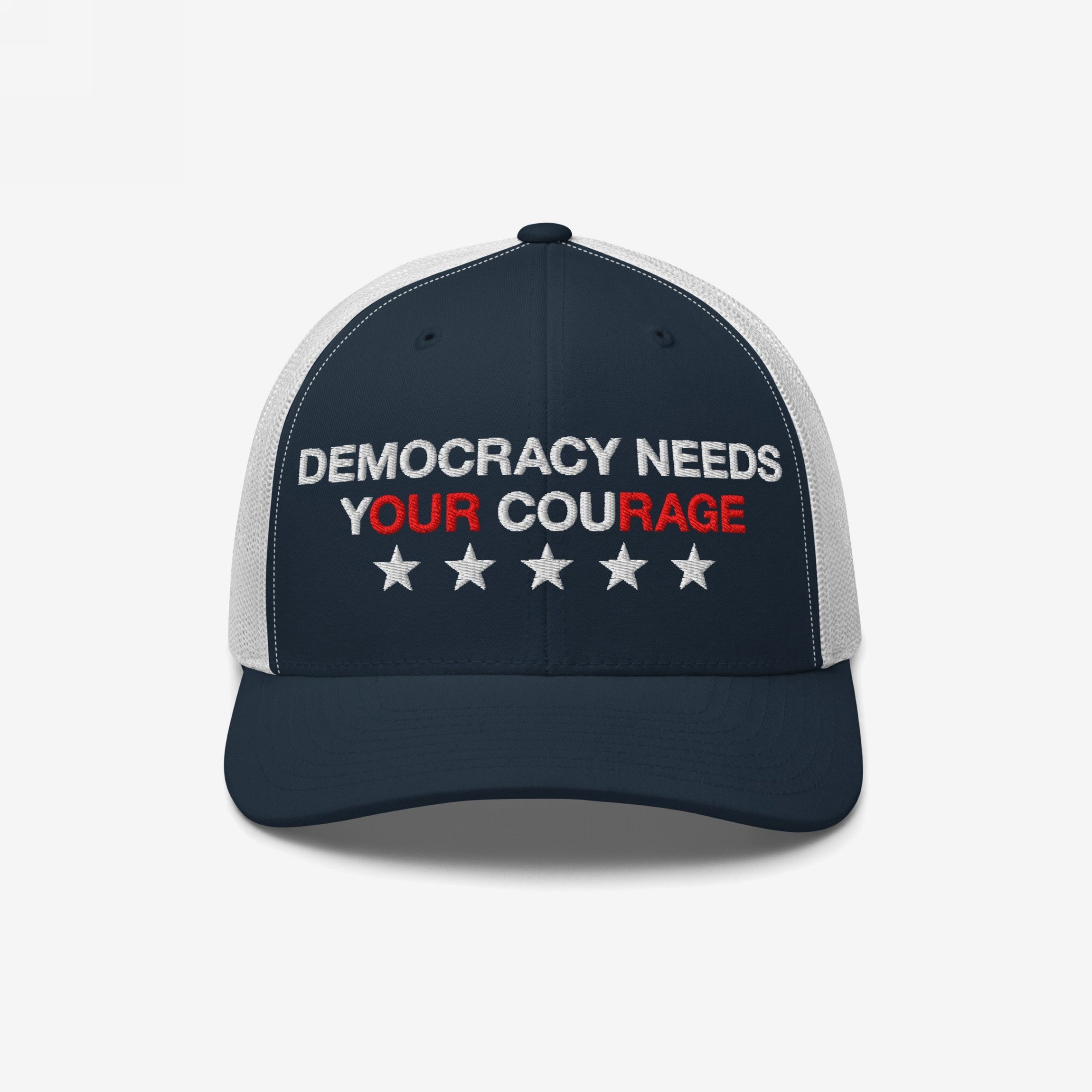 Democracy Hat featuring DEMOCRACY NEEDS YOUR COURAGE slogan with red-highlighted words, embroidered on navy-blue and white mesh trucker cap, adorned with five stars for an empowering statement.