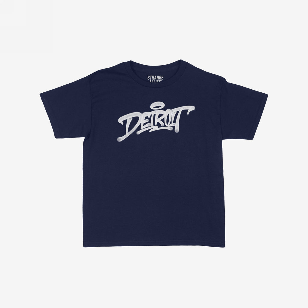 Detroit Handstyle Women's Baby Tee features a navy-blue crew-neck with DETROIT in white graffiti script and a halo accent, embodying urban flair and individuality.